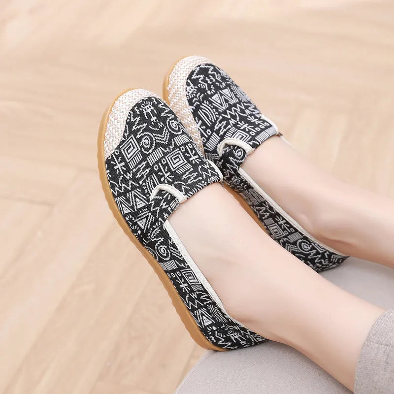 Women's ethnic style flat heel cloth shoes with colour stitching and shallow mouth design.