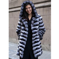 Women's zebra stripe pattern artificial mink faux fur mid-length coat on a hanger.