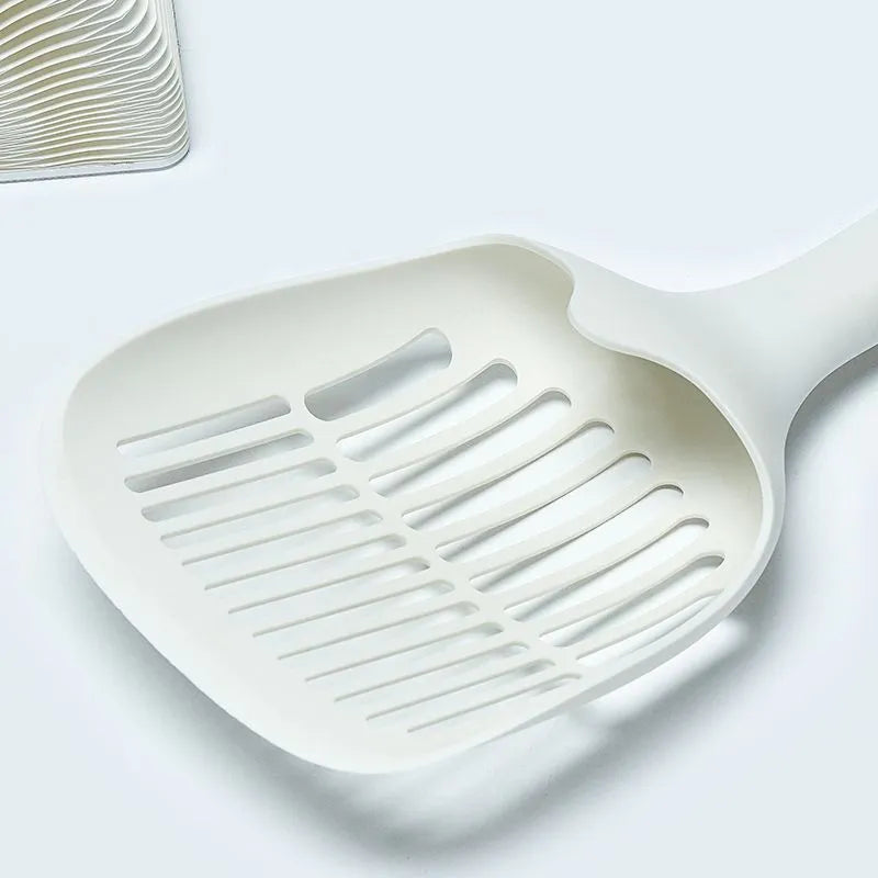 White plastic cat litter scoop with a self-cleaning base on a white background.