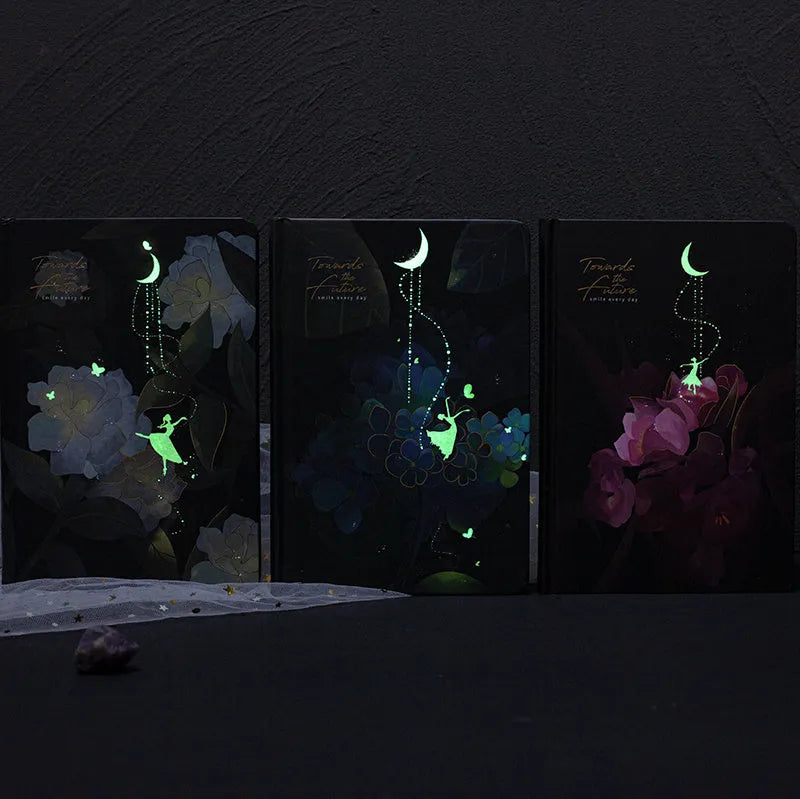 A5 notebook with luminous cover open to show colour illustrated interior pages