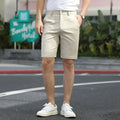 Man wearing grey elastic-waist mid-length casual shorts.