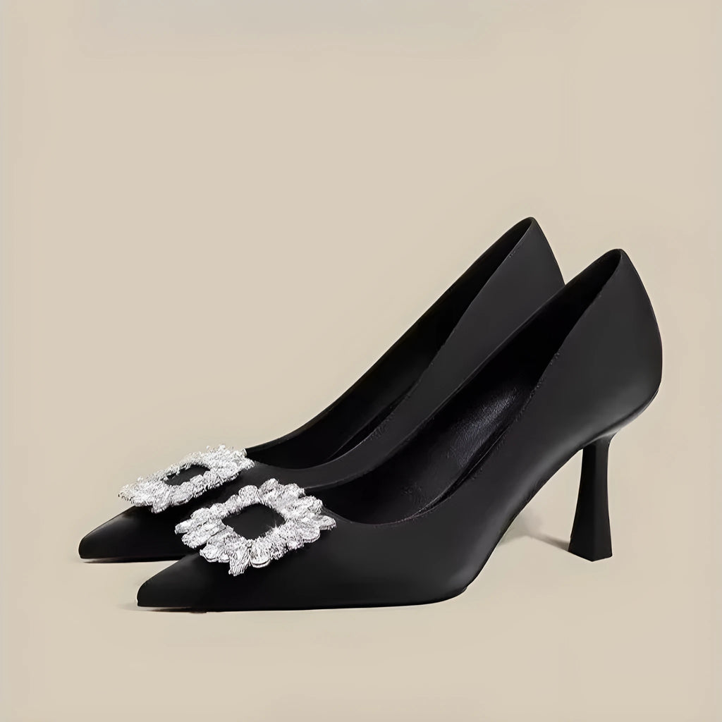 Women's pointed toe stiletto high heels in beige and black, showing low-cut design and thin heel.