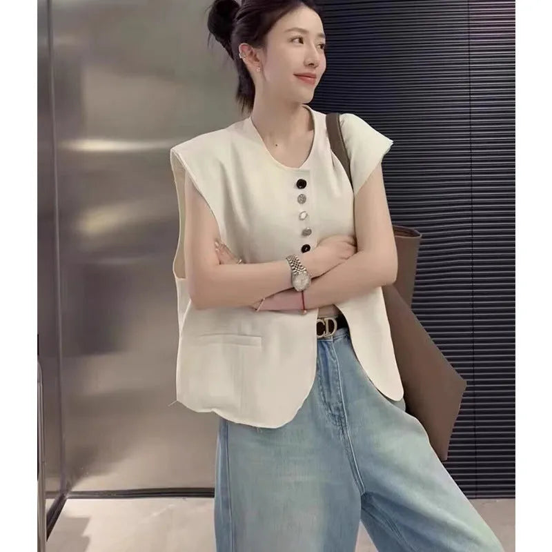 Women's beige loose-fit polyester vest with a pocket, shown on a hanger.