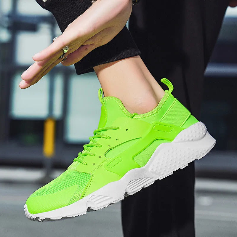 Men's green mesh low-top casual shoes with cross straps and flat sole.