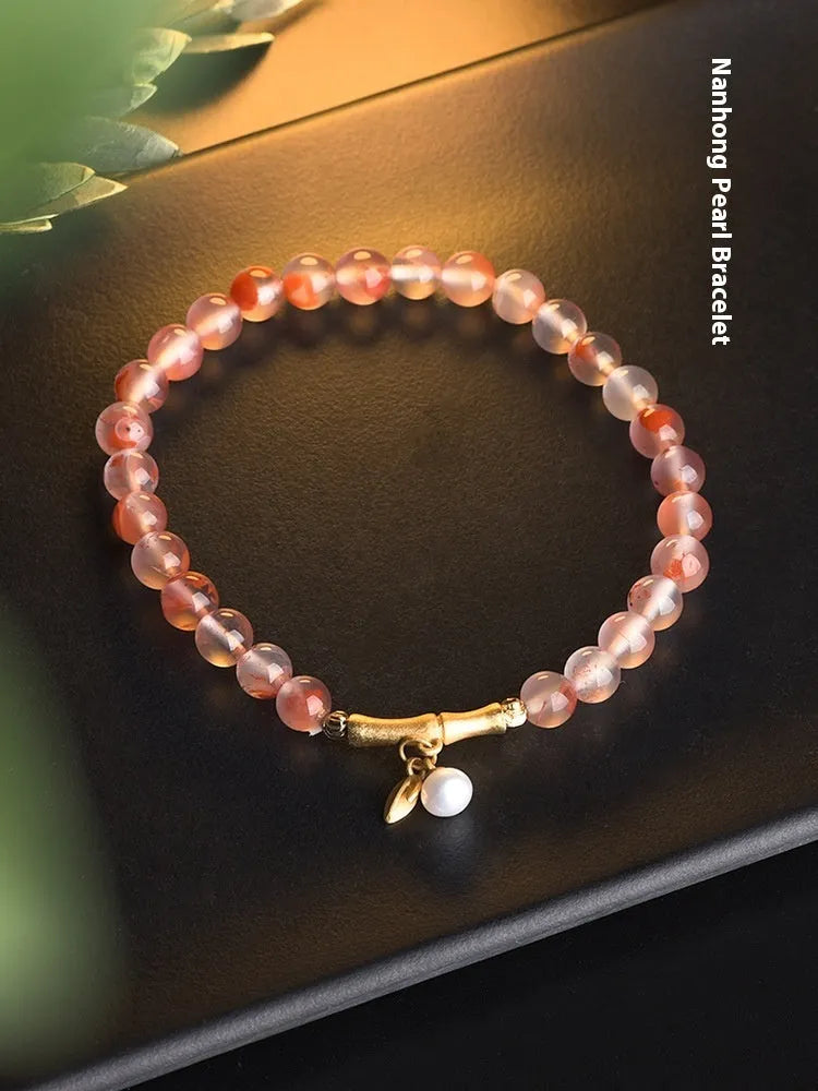 Ice Float Nanhong Agate bracelet with flower shape and bamboo joint details in ethnic style.