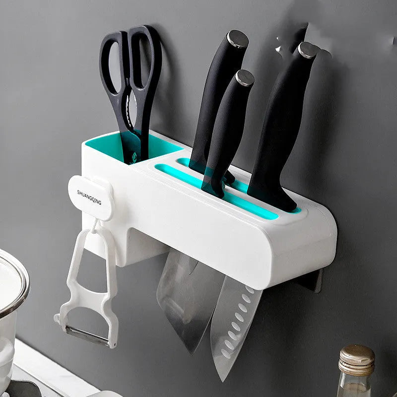 White plastic wall-mounted magnetic knife rack holding several kitchen knives