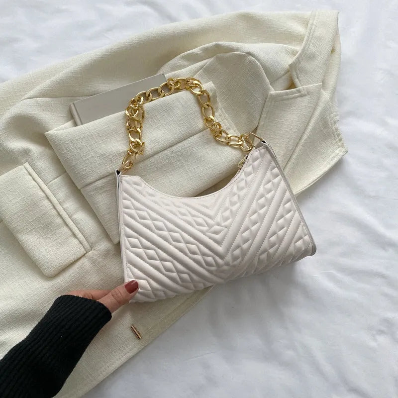 A women's black pleated chain baguette shoulder bag with a vertical square shape and an adjustable strap.