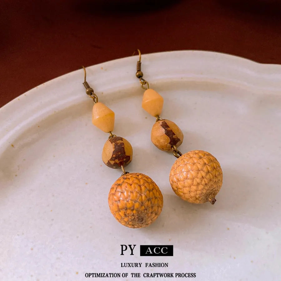 Brown resin fruit core tassel earrings with round geometric design and ear hook clasp for women