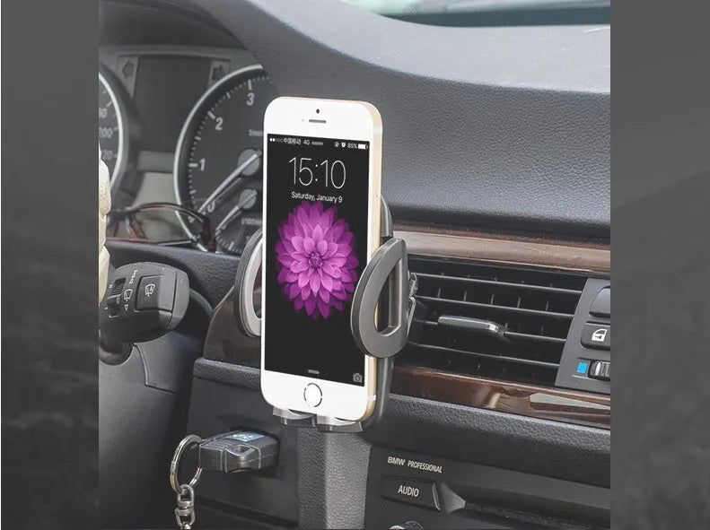 Black plastic universal mobile phone holder mounted on car air vent