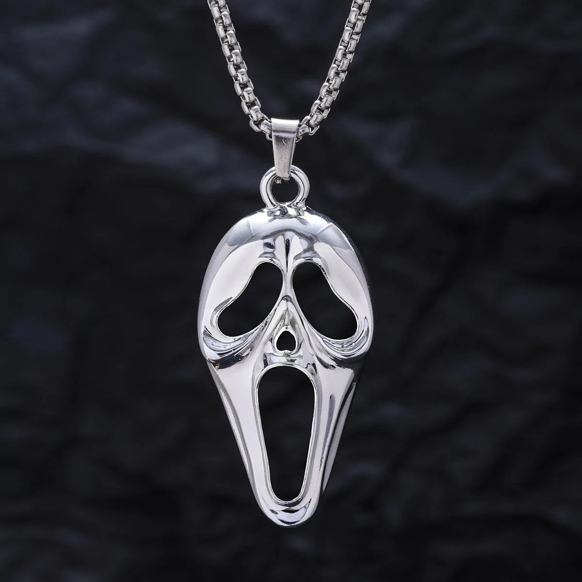 Exaggerated skull luminous mask pendant necklace on square pearl chain, available in luminous blue, luminous green, and hollow out colours