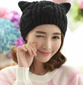 Hand-made 3D knitted cat ear beanie with pom-pom in wool, showing red colour option