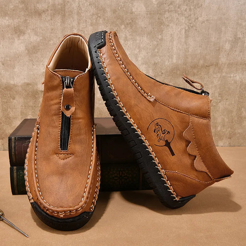 Men's black slip-on leather loafers with round toe and sewn sole detail on a white background.