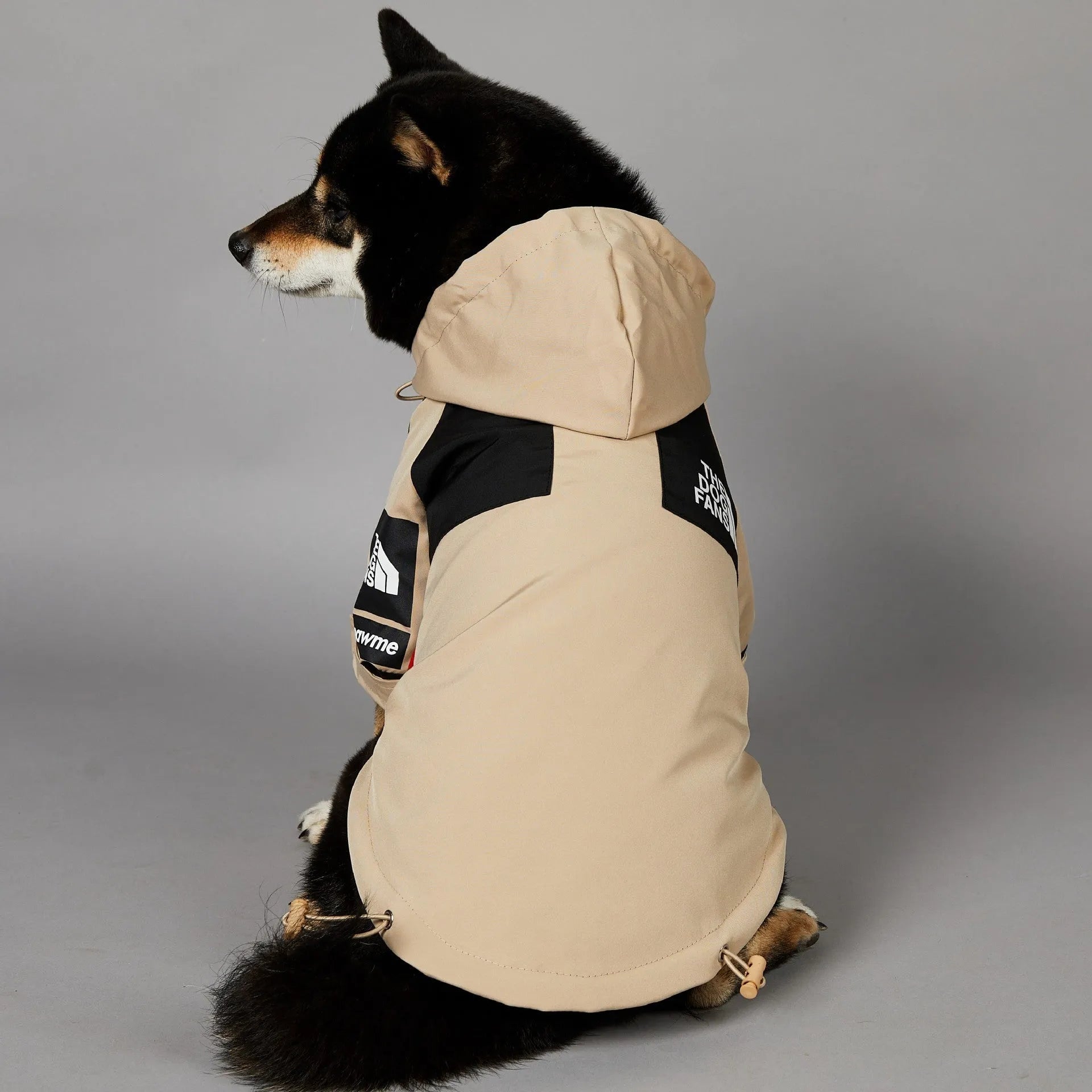 Khaki coloured polyester shell jacket for dogs showing lightweight construction
