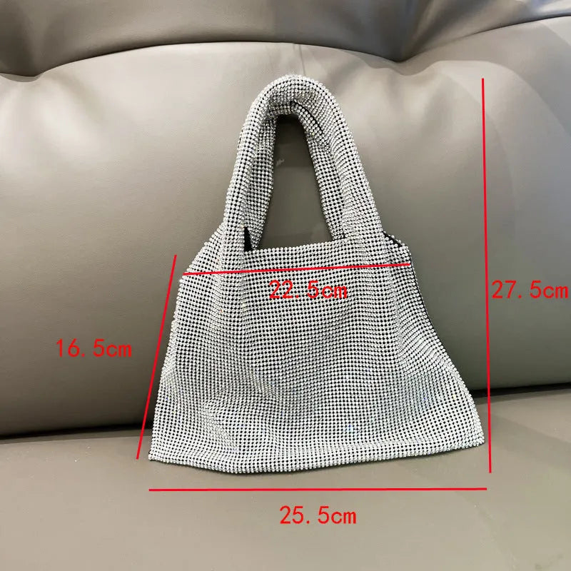 Silver handbag decorated with shiny rhinestones, made from cotton thread with one open pocket.