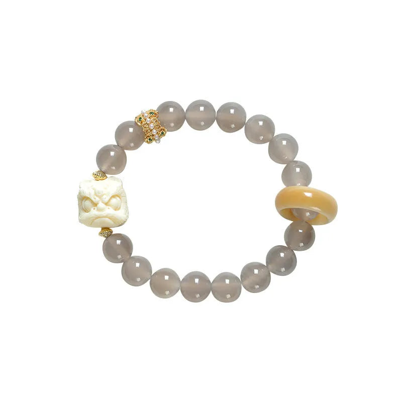Hand-woven grey agate bracelet with 10mm round beads and mellite decorative accents.