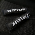Pair of black car safety belt shoulder pads showing sponge cloth padding and embroidery detail