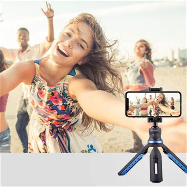 Black desktop mobile phone tripod stand holding a phone, showing adjustable angle bracket.