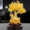 Citrine-coloured resin Feng Shui ornament of a small turtle on a money tree.