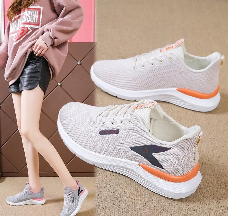 Women's low top casual running shoes in beige with mesh upper, lace-up front, round toe, and soft PVC sole
