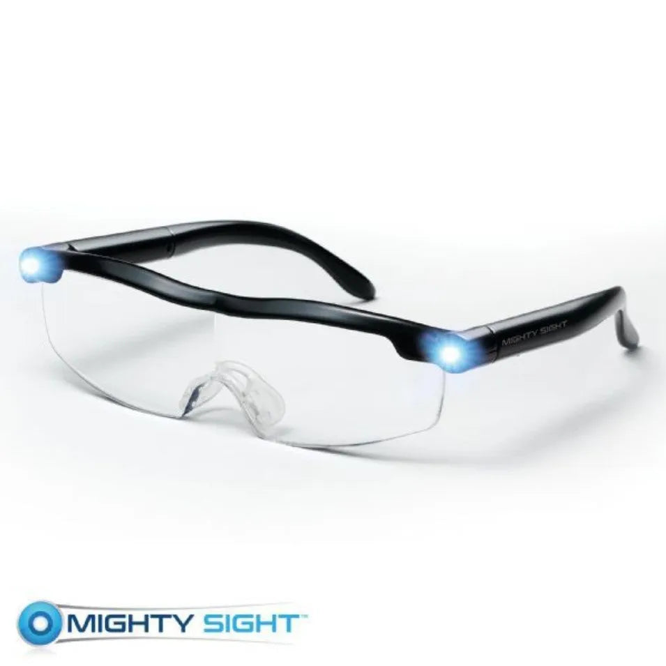 Transparent black USB LED reading glasses with scheduled light control on desktop