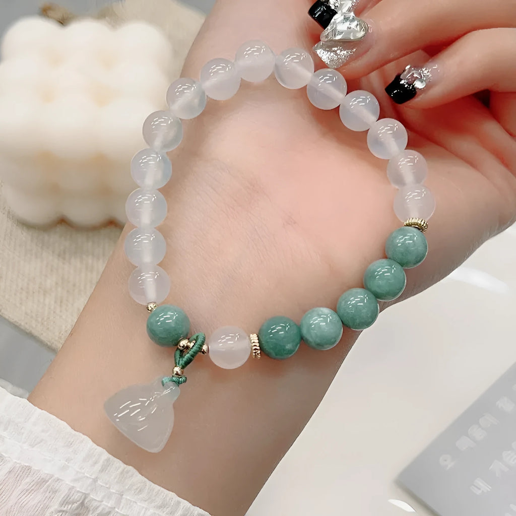 Close-up of a women's retro Chinese style agate bracelet with a lotus seedpod design.