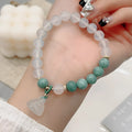 Close-up of a women's retro Chinese style agate bracelet with a lotus seedpod design.