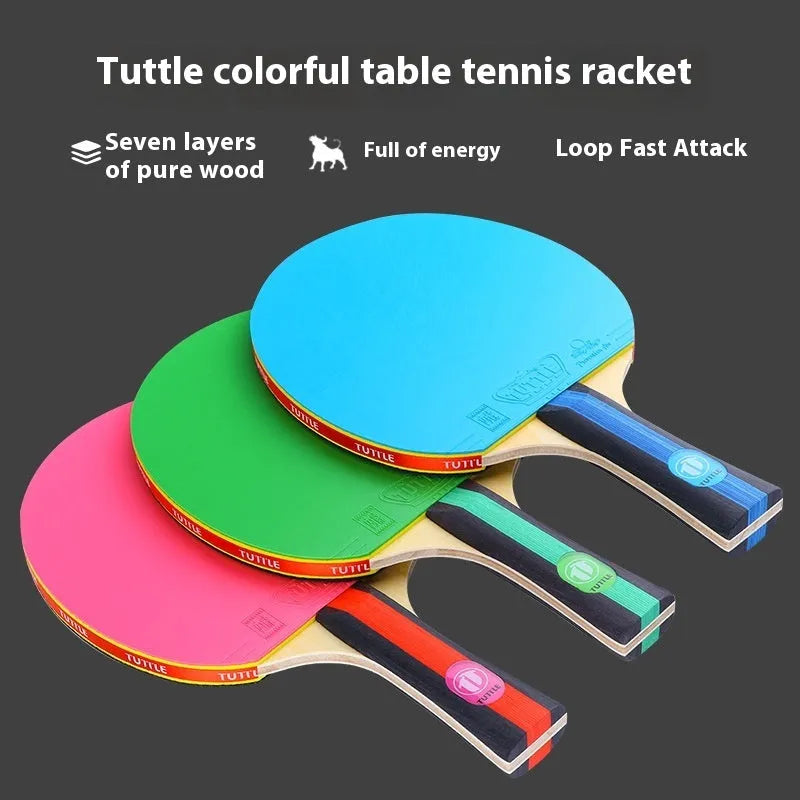 Blue, green, and pink professional table tennis rackets with long shakehand handles and matching carry bags.