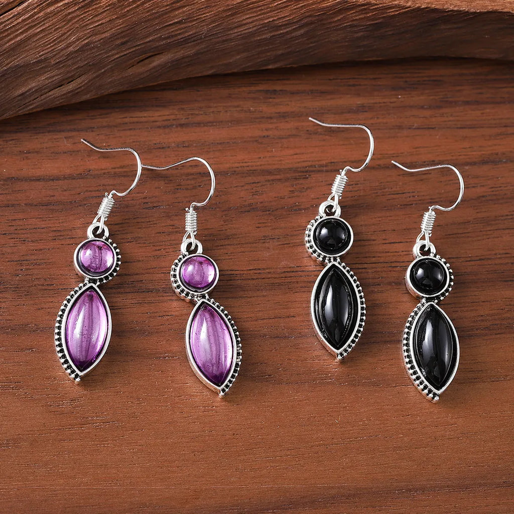 A pair of vintage-style geometric earrings with a black and purple electroplated finish on a zinc alloy base.