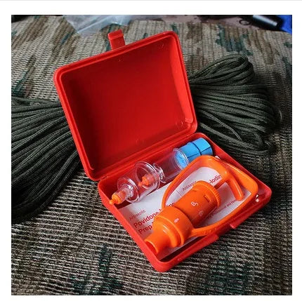 Orange plastic outdoor venom suction device kit open to show pump, two suction cups, tourniquet and swabs.