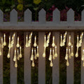 6.5 metre solar LED outdoor string lights with water drop bubble pendants in garden setting