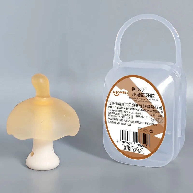 Small pink mushroom-shaped silicone gum replica in a transparent box with a chain.