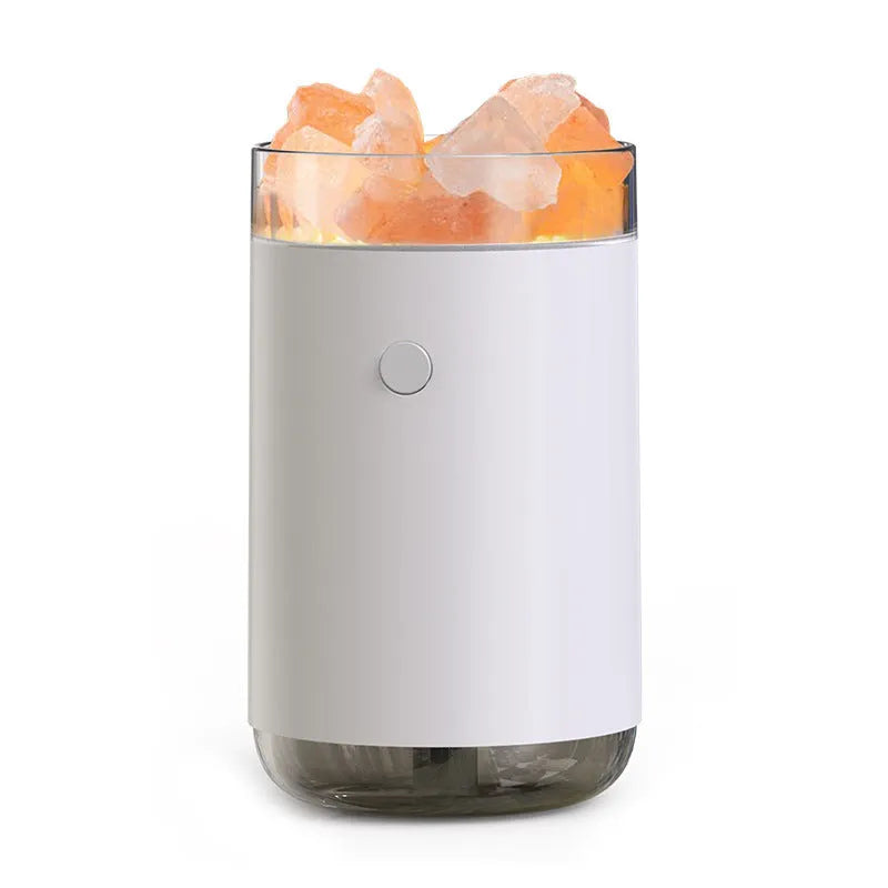 White desktop ultrasonic humidifier with crystal salt stone and LED lamp showing side view on table
