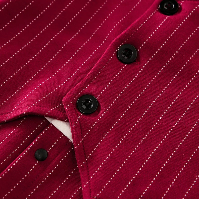 Baby boy wearing a wine red gentleman-style cotton jumpsuit with long sleeves and a single-breasted front.