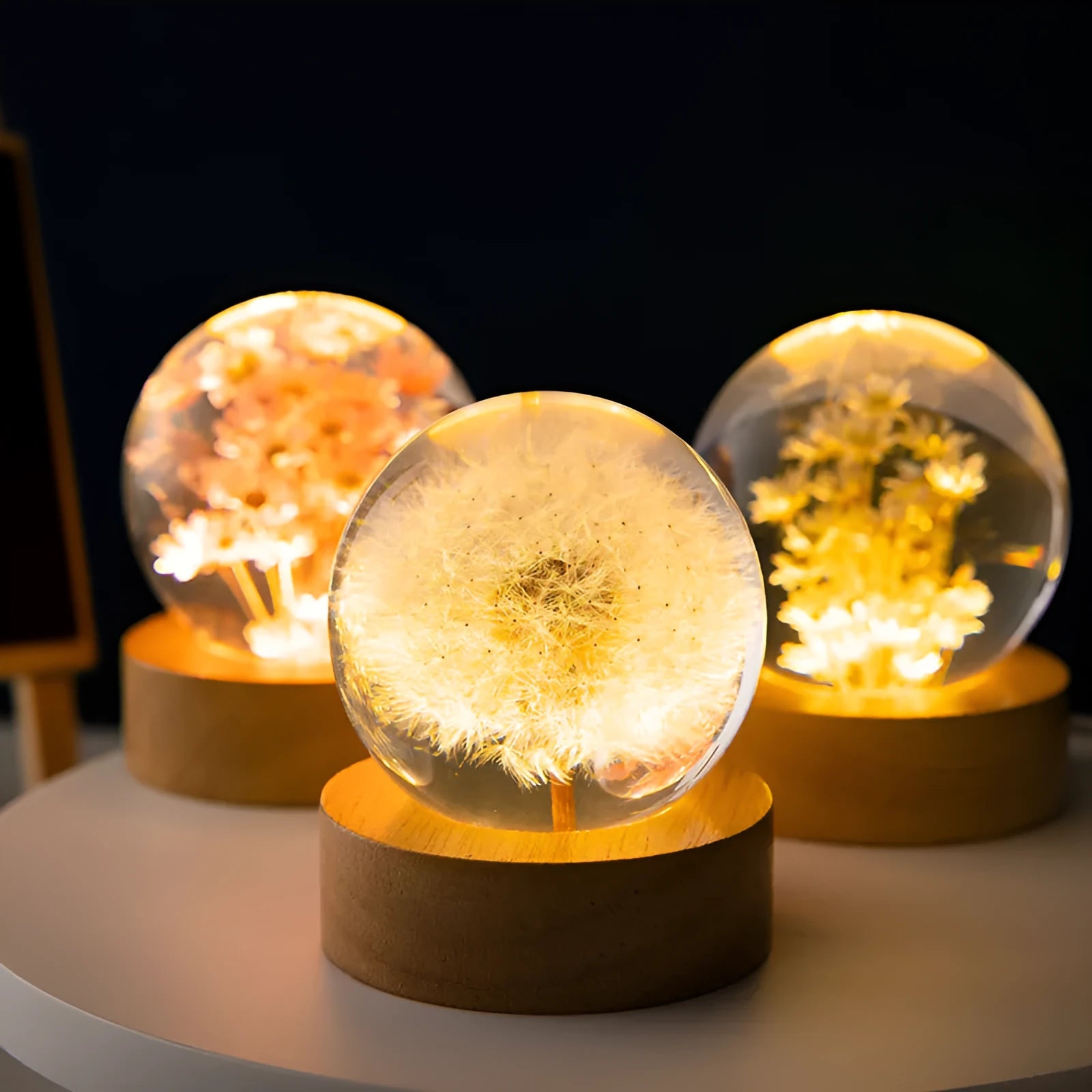 Luminous dandelion preserved in a resin crystal ball on a beech wood stand, USB powered.