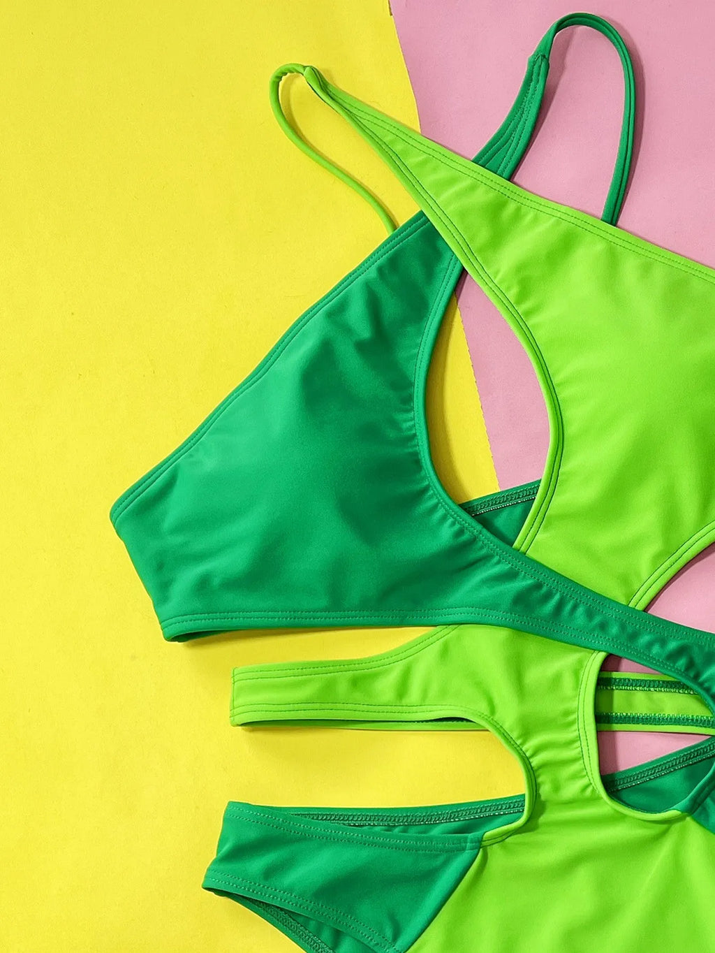 Green solid colour one-piece swimsuit for women with a hollow back, shown on a mannequin.