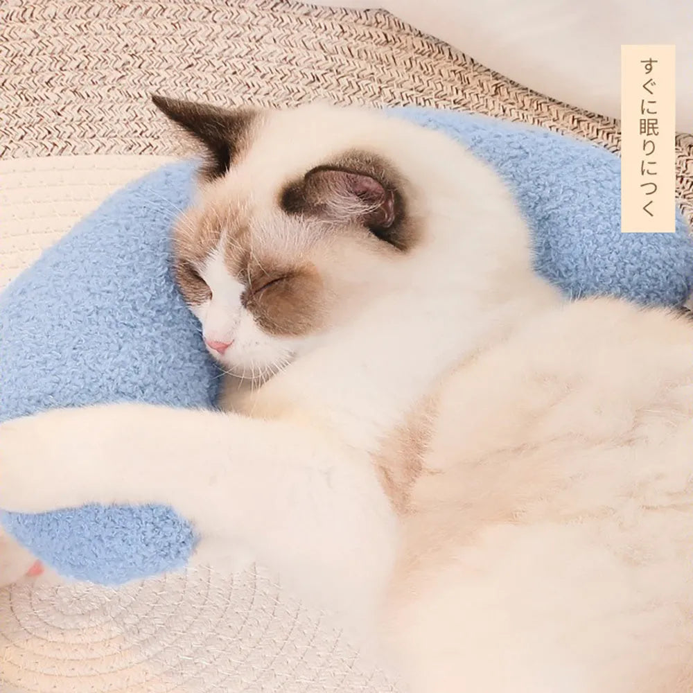Blue U-shaped cat pillow with an adjustable fabric collar resting on a grey blanket.
