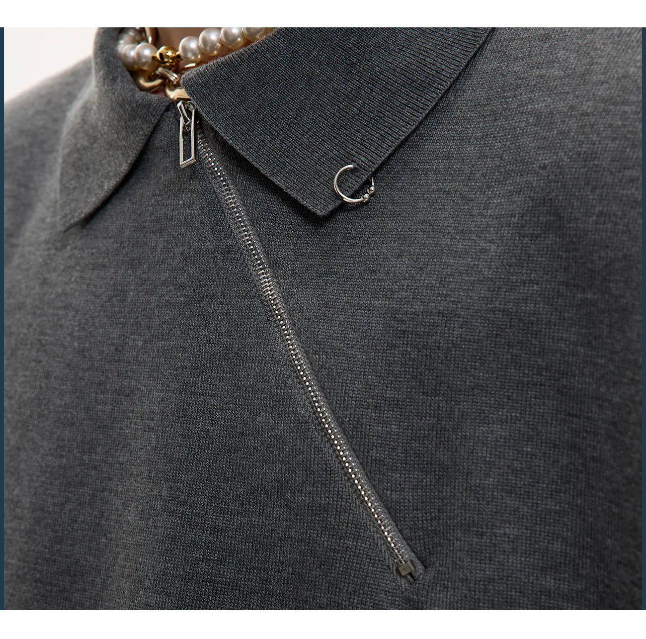 Man modelling a black slim-fit knitted polo shirt with a diagonal chest zipper and lapel collar.
