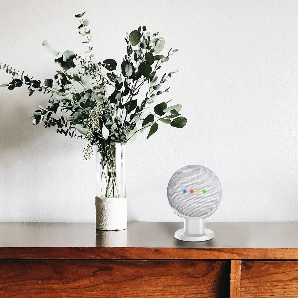 Black PlusAcc Google Home Mini stand with plug-in base on a table.
