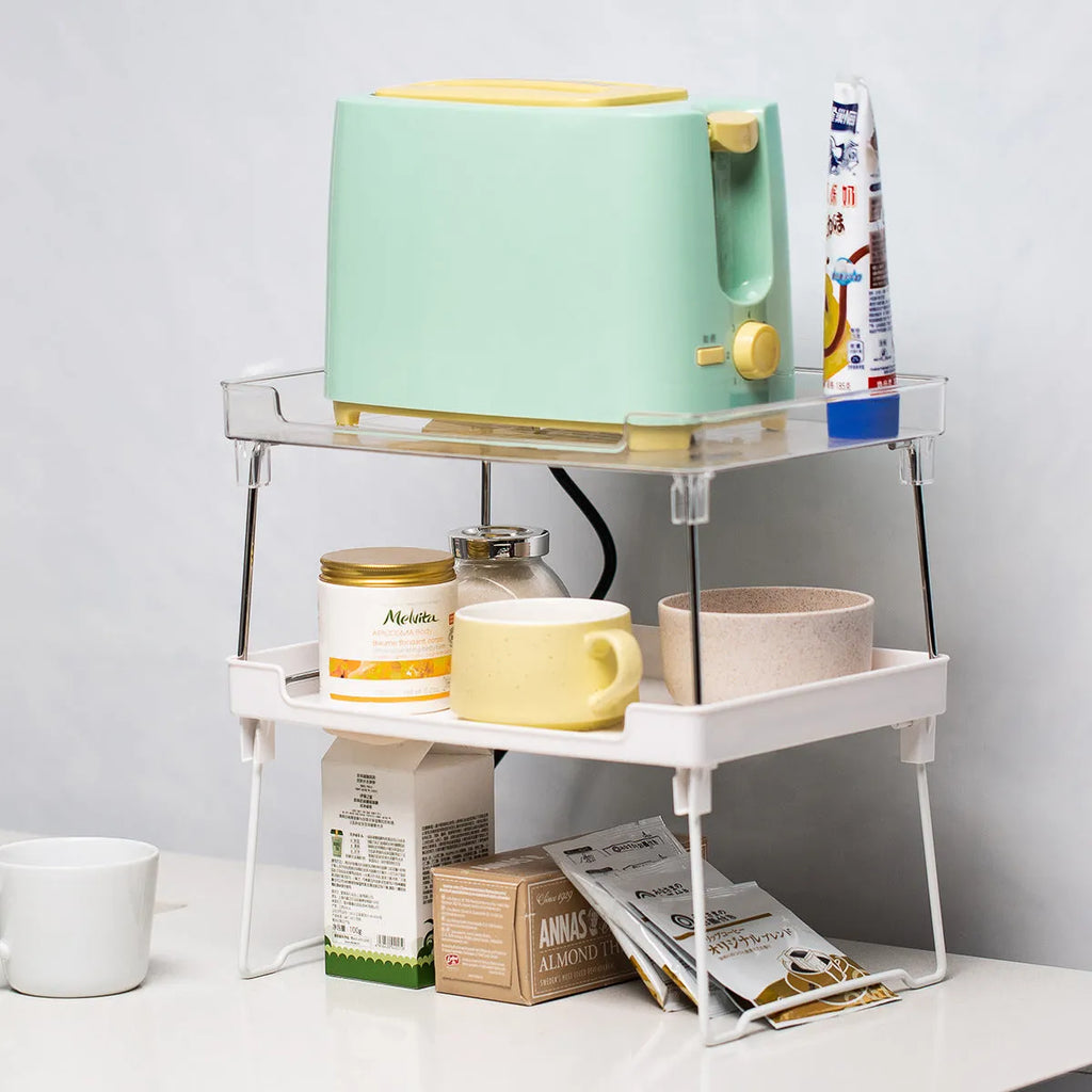 White plastic kitchen supplies rack on a countertop holding spice jars.