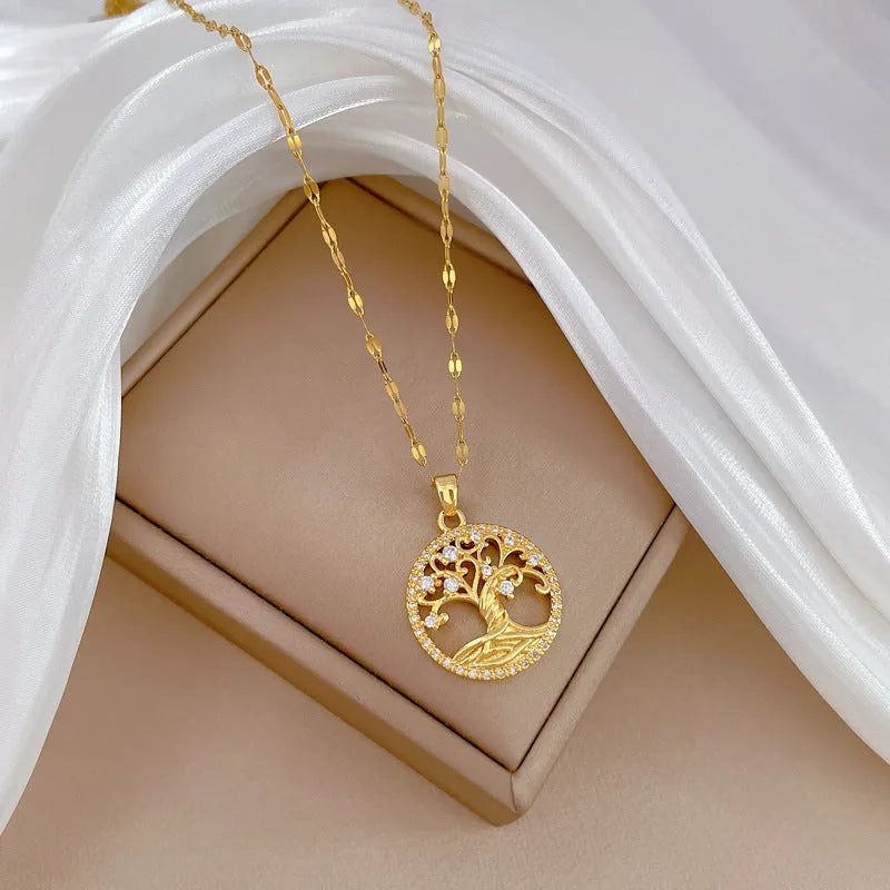 Gold-plated stainless steel necklace with mother-of-pearl and rhinestone pendant on a lip chain.