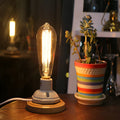Retro American country style ceramic table lamp with a wooden base and glass shade on a wooden table.