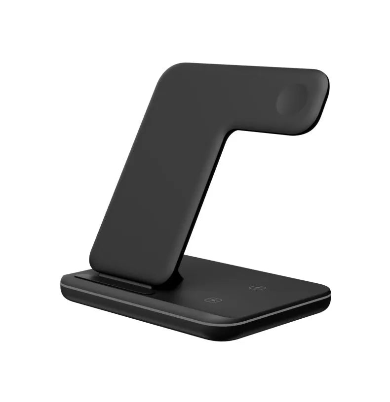 White three-device wireless charging stand on desktop with phone, watch, and headset charging simultaneously