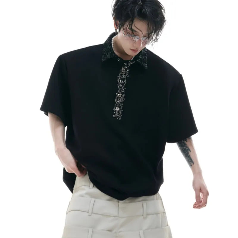 Men's black loose-fit short sleeve polo t-shirt with square collar and heavy embroidery sequin pattern detail.