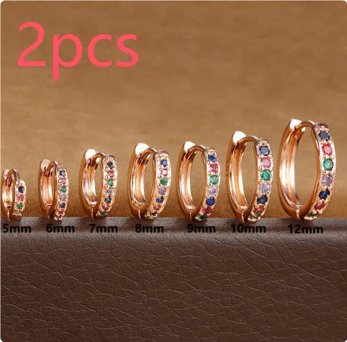 Geometric circle shape zircon perforated stud earrings in gold, rose gold, and silver colour on a white background.