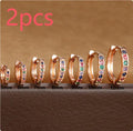 Geometric circle shape zircon perforated stud earrings in gold, rose gold, and silver colour on a white background.