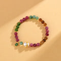 Geometric chalcedony crystal bracelet with 6.5mm beads on a wrist.