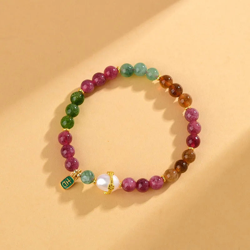 Geometric chalcedony crystal bracelet with 6.5mm beads on a wrist.