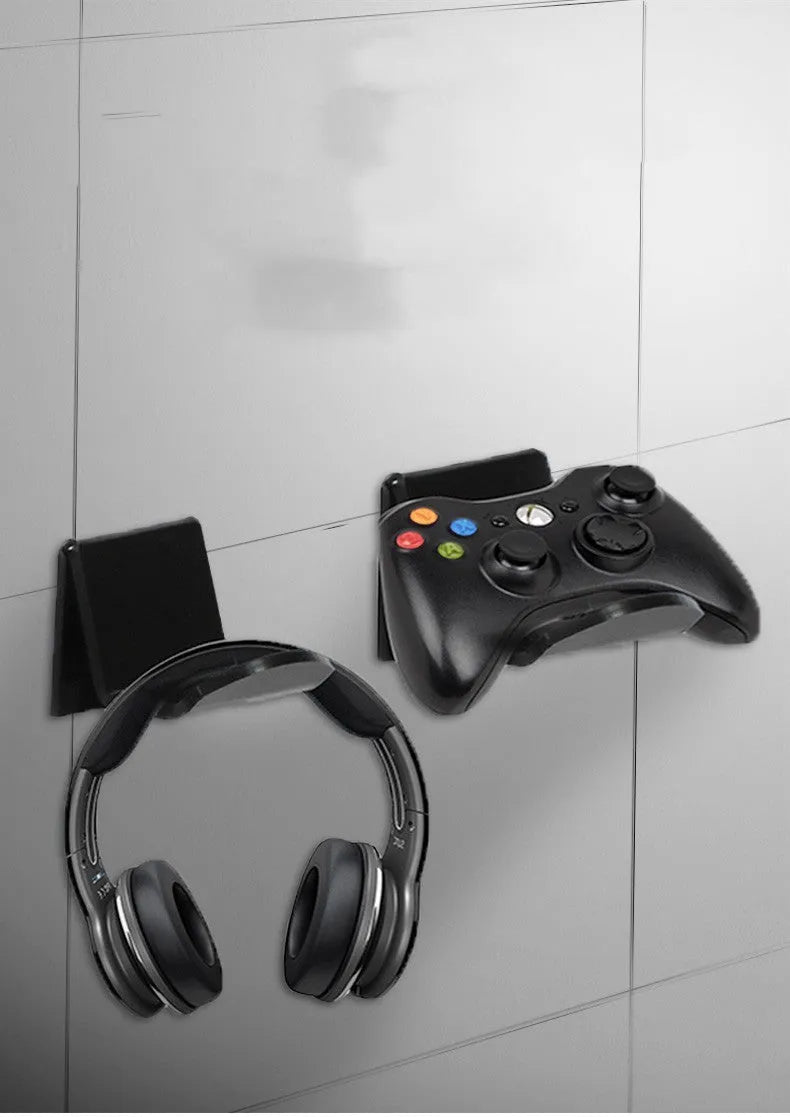 Universal game controller wall mount bracket in black plastic with gaming controller inserted