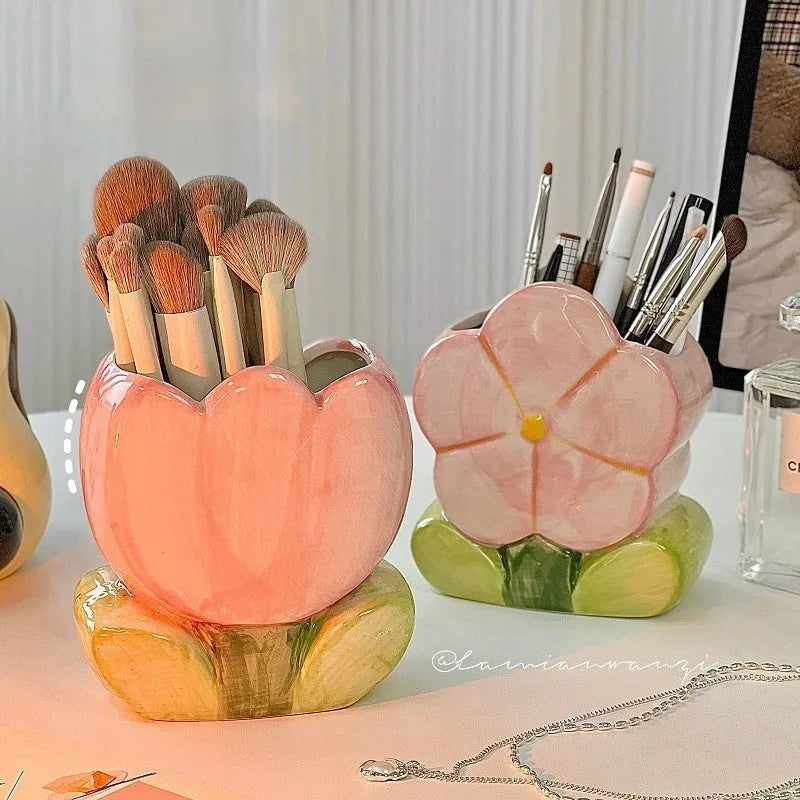 Ceramic flower pen holder in a floral pattern, showing its size next to pens for scale.