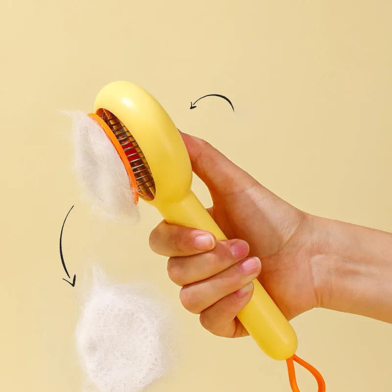 Small yellow and white pet grooming comb with needle teeth for cat and dog hair removal.